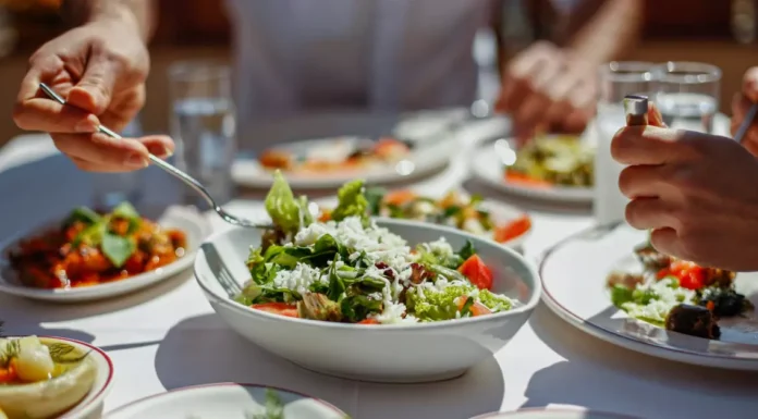 Here's a colorful plate of fresh spinach leaves and vegetables.