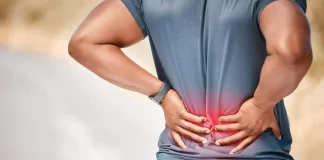 A man experiences lower back pain, emphasizing the significance of recognizing symptoms.