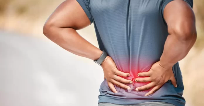 A man experiences lower back pain, emphasizing the significance of recognizing symptoms.
