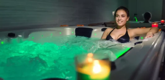 A person enjoying a relaxing hot bath symbolizes the soothing and holistic wellness effects of regular hot water therapy.
