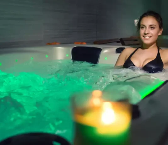 A person enjoying a relaxing hot bath symbolizes the soothing and holistic wellness effects of regular hot water therapy.