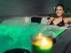A person enjoying a relaxing hot bath symbolizes the soothing and holistic wellness effects of regular hot water therapy.