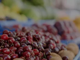 Various colorful Canadian fruits arranged on a market stall