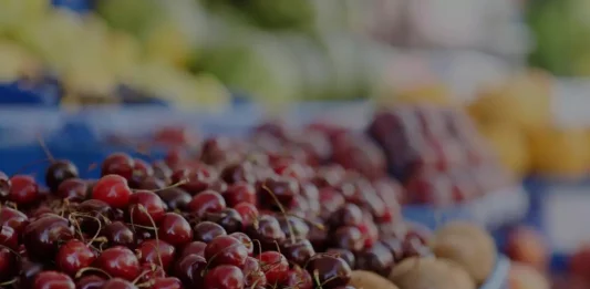 Various colorful Canadian fruits arranged on a market stall