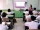Classroom scene showing teachers interacting with students in a K-12 setting in the Philippines.