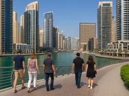 Skyline of Dubai with residential buildings and ex-pats walking near the marina