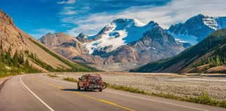 A happy family enjoying outdoor life in Canada with scenic mountains in the background.