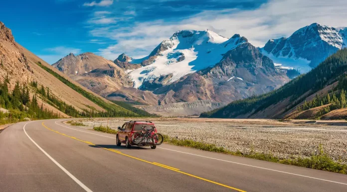 A happy family enjoying outdoor life in Canada with scenic mountains in the background.