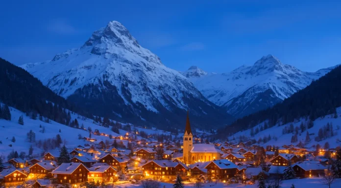 Scenic snowy mountain village illuminated with winter lights, representing the best countries to visit in winter.