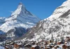 Snow-covered Zermatt village beneath the Matterhorn in the Swiss Alps during winter.