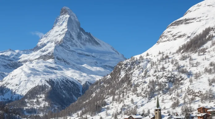 Snow-covered Zermatt village beneath the Matterhorn in the Swiss Alps during winter.