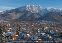 Zakopane in winter with snowy mountains, ski slopes, and wooden chalets in Poland.