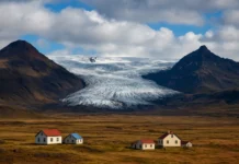 Iceland landscape showing glaciers, volcanoes, and rural terrain under cloudy skies.
