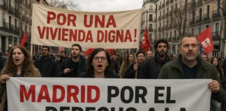 Protesters holding banners about housing in Madrid, Spain.