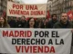 Protesters holding banners about housing in Madrid, Spain.