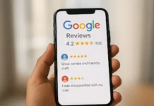 Hand holding a mobile phone showing Google reviews stars and comments